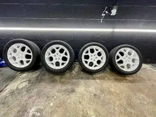 Four white alloy wheels with ceramic coating applied