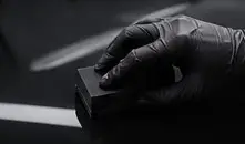 Gloved hand applying ceramic coating with an applicator block