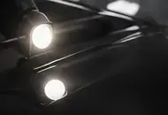 Inspection lights reflecting in glossy black paint